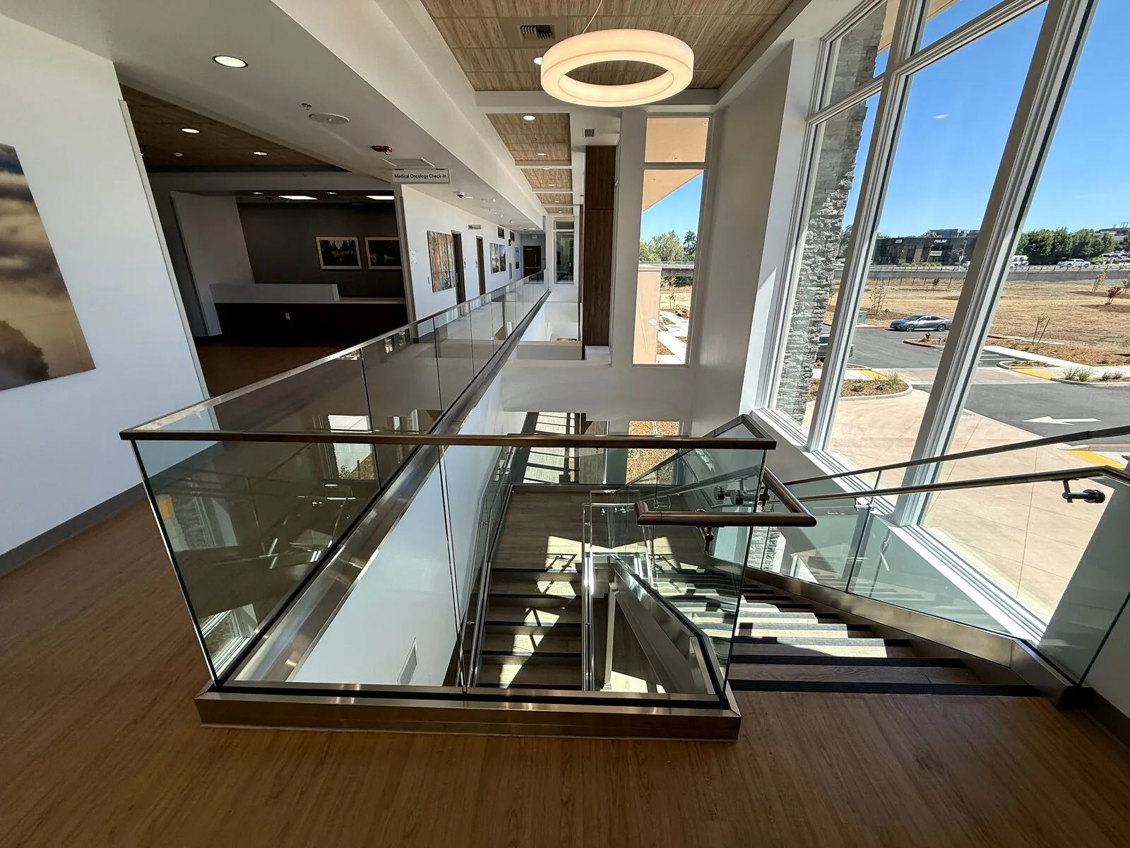 Glass mezzanine guardrail overlooking the lobby of the health care building